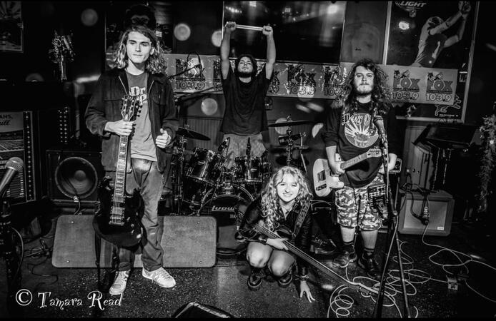 Image of the band sandspit (by Tamara Reed), in black and white. Depicts from left to right: name, name, Ariel, Max)
